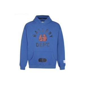 May include: A blue hoodie with a front pocket and a hood. The front of the hoodie features the text "GALLERY DEPT." above a graphic of two boxing gloves. Below the text is the word "DEPT." and a black "L" size tag.