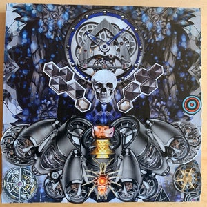 May include: A mixed media collage featuring a skull, gears, and geometric shapes. The artwork incorporates shades of blue, gray, and silver, with a central focus on mechanical and anatomical elements. The composition includes a clock-like structure and a compass.