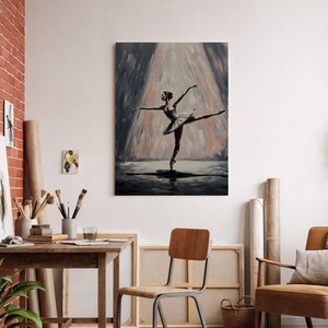 May include: Oil painting of a ballerina in a white tutu and pointe shoes, performing on a stage. The artwork features a spotlight effect, with a dark background and a focus on the dancer's graceful pose. The painting is displayed on a wall in a room with a wooden desk and chair.