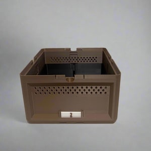 May include: A brown plastic storage bin with a rectangular shape. The bin has a series of diamond-shaped perforations on the sides and a black interior. A white label with the number "2" is visible on the front.