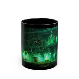 May include: Black ceramic mug featuring a green illustration of a spider, cobwebs, and glowing green bottles. The design has a spooky, Halloween theme. The mug is cylindrical and has a black interior.