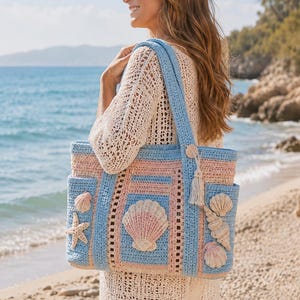 May include: A light blue, pink, and cream crochet tote bag with seashell and starfish appliqués. The bag has a rectangular shape with a blue strap and a tassel. The bag is carried on the shoulder.