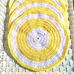 Set of four hand-crocheted lemon yellow and white dining placemats and coasters