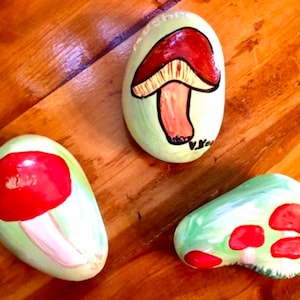 A trio of hand-painted mushroom rocks decoration