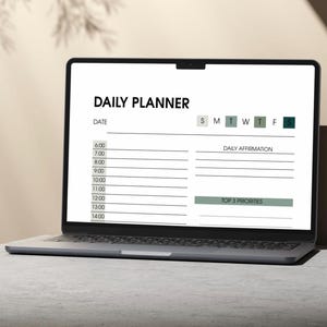 May include: A laptop displaying a digital daily planner. The screen shows a white background with the words "DAILY PLANNER" at the top. The planner includes sections for the date, daily affirmations, and top 3 priorities.
