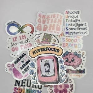 May include: A selection of vibrant stickers with diverse designs and text. The stickers display phrases such as "Anxiety Autism ADHD," "Hyperfocus," and "Neuro Sparkly." Other designs include an infinity symbol and a brain with bows.