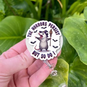 The Horrors Persist But So Do I Opossum Badge Reel – Dark Humor Retractable ID Holder, Nurse Gift, Mental Health Resilience Accessory