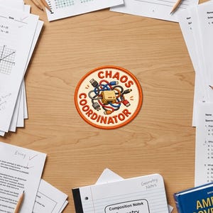 May include: A circular embroidered patch with an orange border featuring a central illustration of a yellow electronic device surrounded by a tangle of blue, red, and black cables. The text CHAOS COORDINATOR is printed in orange capital letters.