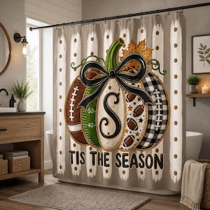 May include: A shower curtain featuring a large central pumpkin graphic with a black bow, the letter S, and football-themed patterns including laces and gridiron lines. The background has beige and white vertical stripes with brown polka dots and the text TIS THE SEASON.