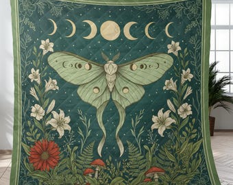 May include: A quilted blanket with a dark teal background featuring a large moth with moon phase details. The design includes white lilies, red flowers, mushrooms, and ferns, framed by a green border.