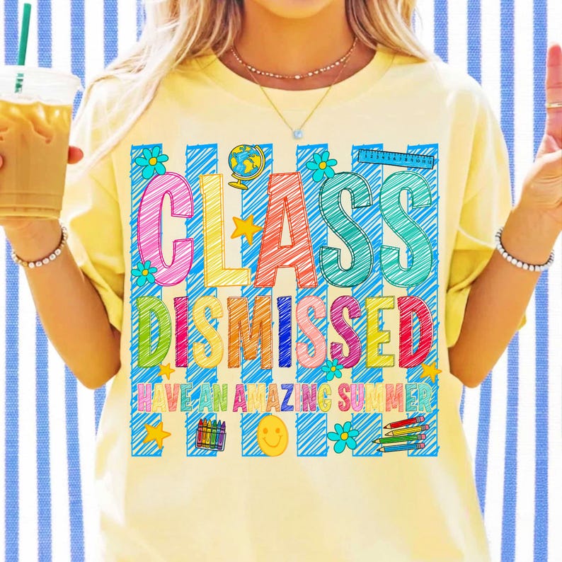 May include: A pale yellow t-shirt featuring a colorful graphic with blue vertical stripes and the text "CLASS DISMISSED" and "HAVE AN AMAZING SUMMER." The design includes illustrations of a globe, flowers, a ruler, crayons, and a smiley face.