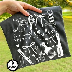 May include: Dark gray fabric with white illustrations of hairstyling tools, including a hairdryer, comb, scissors, and curling iron. The words "Hair Stylist" are written in a cursive font, along with stars and bows. A circular graphic in the bottom left corner reads "4 PNGS."
