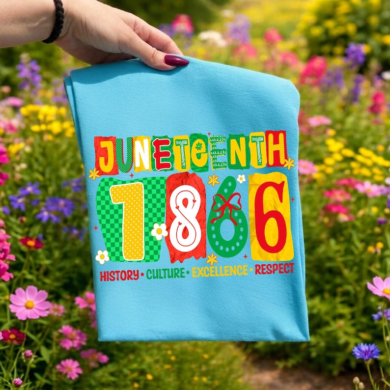May include: A light blue t-shirt featuring the text JUNETEENTH 1866 in colorful, patterned block letters. Below the date, the words HISTORY, CULTURE, EXCELLENCE, and RESPECT are printed in yellow and red. Small white flower icons decorate the design.