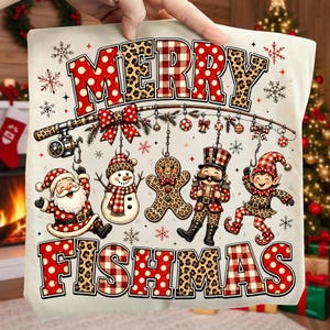 May include: A cream-coloured fabric featuring the text MERRY FISHMAS in red polka dot and leopard print letters. A fishing rod hangs ornaments, a Santa Claus, a snowman, a gingerbread man, a nutcracker, and an elf, all with festive patterns.