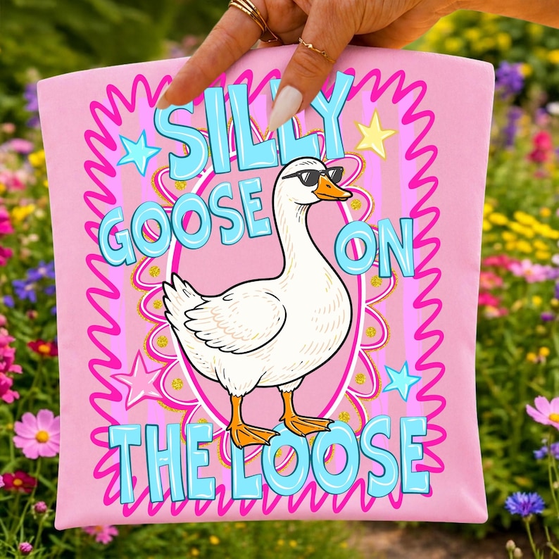 Mockup of a children's t-shirt showcasing the funny Silly Goose On The Loose sublimation design.