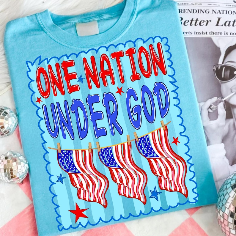Close-up of the 'One Nation Under God' distressed patriotic font and graphic elements, showcasing vibrant red, white, and blue textures.
