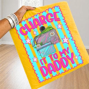May include: A yellow blanket featuring a bright blue scalloped border with vertical stripes and pink stars. The center graphic shows a wallet and credit card with the text "CHARGE IT TO MY DADDY" in bold pink letters, accented by small white flowers.