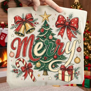 May include: A cream-colored fabric square featuring a festive illustration with the word Merry in red and gold script. The design includes a central green Christmas tree, gold bells with red bows, a candy cane, a gift box, and ornaments.