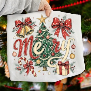 May include: A white fabric item featuring a festive graphic with the word Merry in large red script. The design includes a central green Christmas tree, two gold bells with red bows, a red and white candy cane, a gift box, and gold stars.