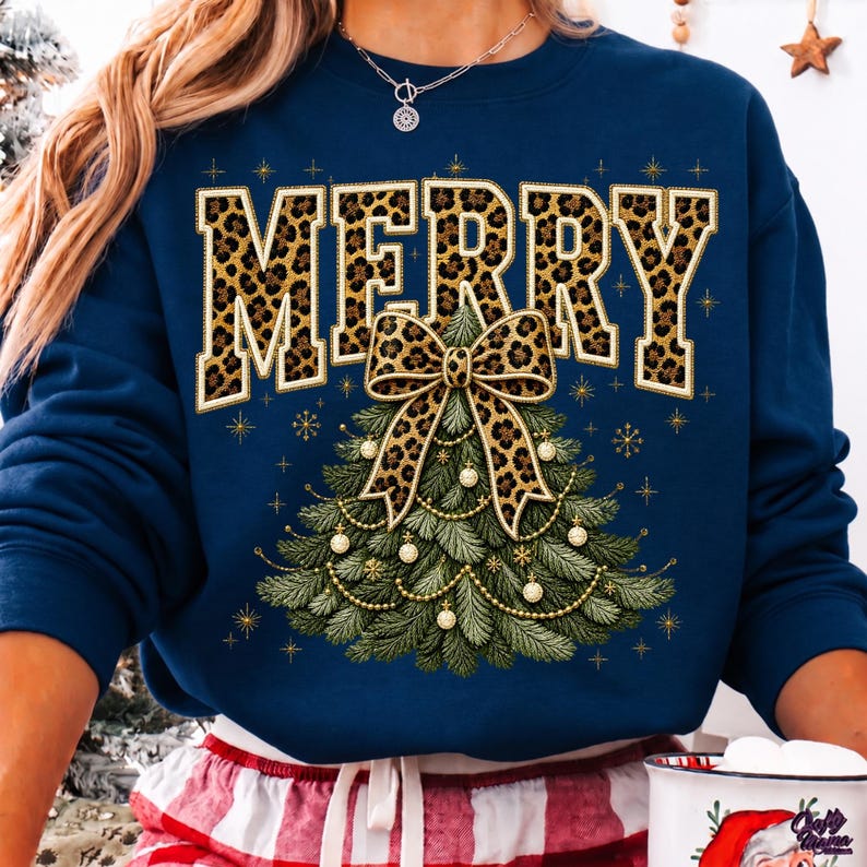 Op de afbeelding: Een marineblauw sweatshirt met lange mouwen en het woord MERRY in grote blokletters met een luipaardprint. Onder de tekst staat een afbeelding van een groene kerstboom versierd met gouden kralen, kleine witte ornamenten en een grote luipaardstrik.