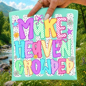 May include: A light mint green fabric square featuring the text MAKE HEAVEN CROWDED in colorful, patterned block letters. The design includes polka dots, checkerboard patterns, and small flower and star accents, all set against vertical black and white speckled stripes.