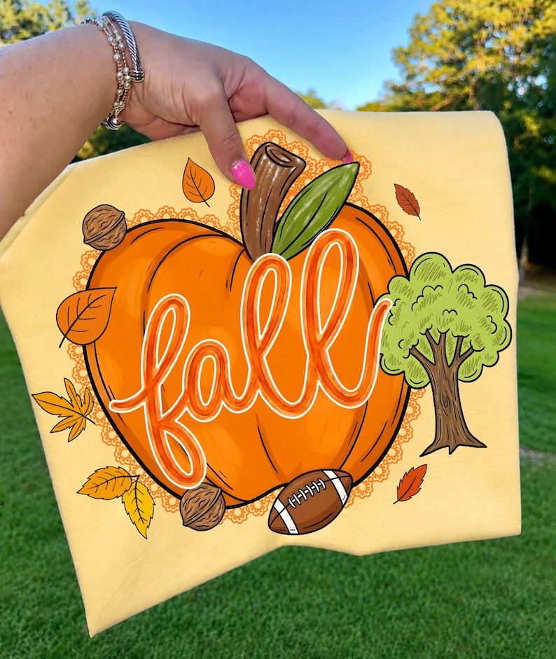Boho Autumn Pumpkin Football PNG design on a rustic wooden background, showcasing lace and fall elements.