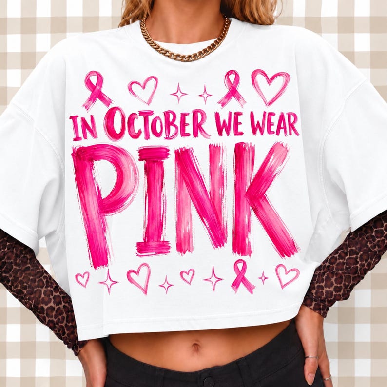 Custom pink ribbon merchandise displayed on a wooden table