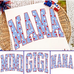 May include: A white t-shirt featuring the word MAMA in large, arched, light blue block letters with a red outline. The letters are filled with a pattern of small red and white stars. Additional text options include MIMI, GIGI, and NANA in the same style.