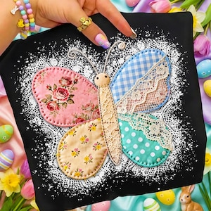 May include: Black square pillow featuring a colorful butterfly applique. The butterfly has pink floral, blue gingham, and turquoise polka dot wings, with a beige lace-trimmed body. The pillow is surrounded by a white lace design.