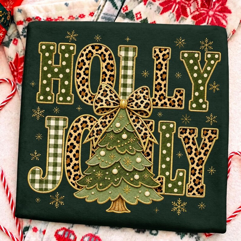 May include: A dark green sweatshirt featuring the embroidered text HOLLY JOLLY. The letters are filled with green polka dots, leopard print, and green gingham patterns. A central embroidered Christmas tree with a leopard print bow sits between the words.