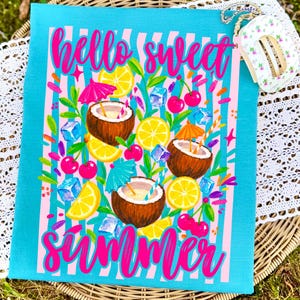 May include: A turquoise t-shirt featuring a pink and white vertical striped background with the text hello sweet summer in pink script. The graphic includes illustrations of coconuts, lemon slices, cherries, ice cubes, and cocktail umbrellas.