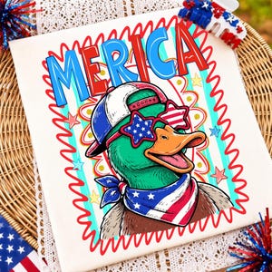May include: A white t-shirt featuring a graphic of a green duck wearing a baseball cap, star-shaped sunglasses with American flag patterns, and a matching bandana. The text MERICA is printed in large blue and red letters above the duck.