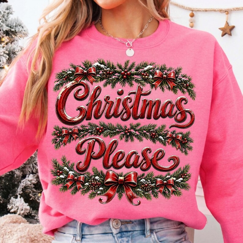 May include: A bright pink crewneck sweatshirt featuring a graphic print of green pine branches, red berries, and red bows arranged in horizontal bands. The text "Christmas Please" is printed in a bold, red, stylized font across the center.