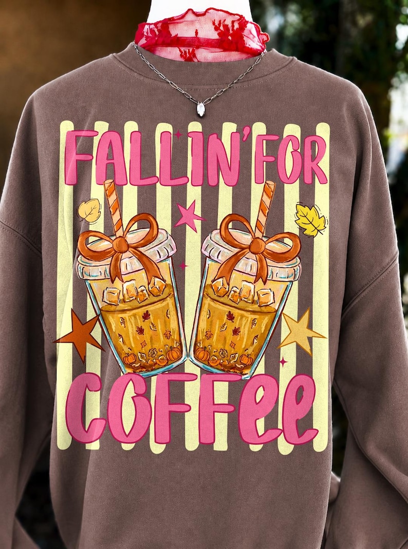 A close-up of the 'Fallin' For Coffee' PNG design featuring an iced coffee cup with a coquette bow, autumn leaves, and 'Fallin' For Coffee' text.