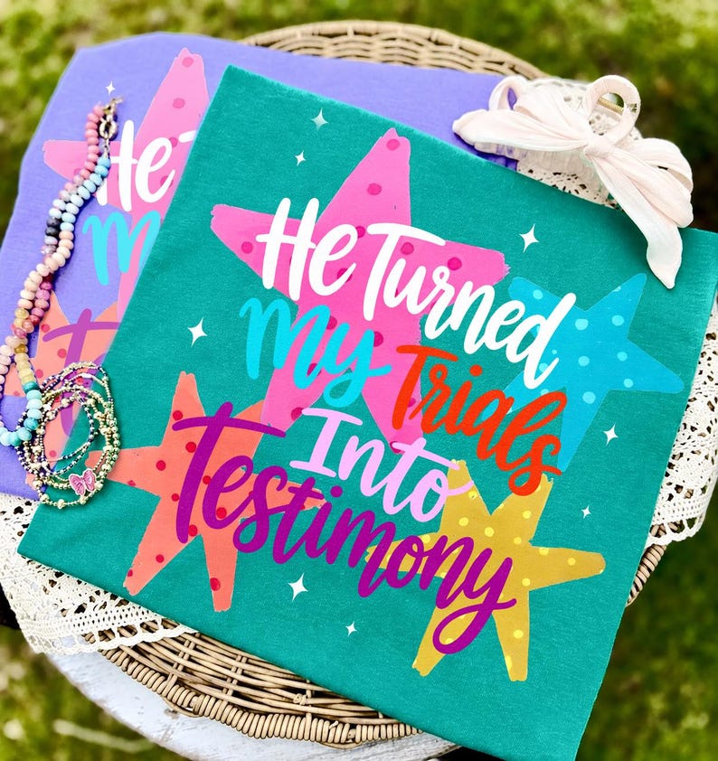 Inspiring 'He Turned My Trials Into Testimony' retro stripe PNG design on a stylish t-shirt mock-up.
