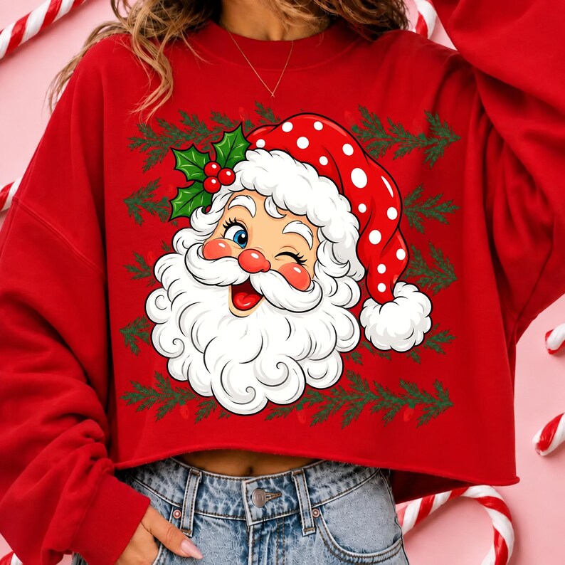 May include: A red long-sleeve sweatshirt featuring a graphic of a winking Santa Claus wearing a red hat with white polka dots. The design includes green holly leaves with red berries and a repeating pattern of green pine branches in the background.