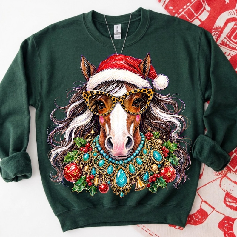 May include: A dark green crewneck sweatshirt featuring a graphic of a horse wearing a red Santa hat, leopard print sunglasses, and a decorative necklace made of turquoise stones, gold bells, red ornaments, and green holly leaves.