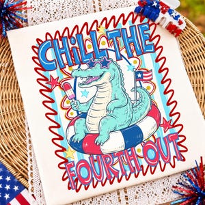 May include: A white t-shirt featuring a graphic of a light blue alligator wearing star-shaped sunglasses, sitting in a red, white, and blue striped pool float while holding a popsicle. The text CHILL THE FOURTH OUT is printed in blue.