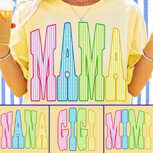 May include: A pale yellow t-shirt featuring the word MAMA in large, colorful, vertically striped letters. The letters are pink, blue, green, and yellow. Additional text options shown below include NANA, GIGI, and MIMI in the same style.