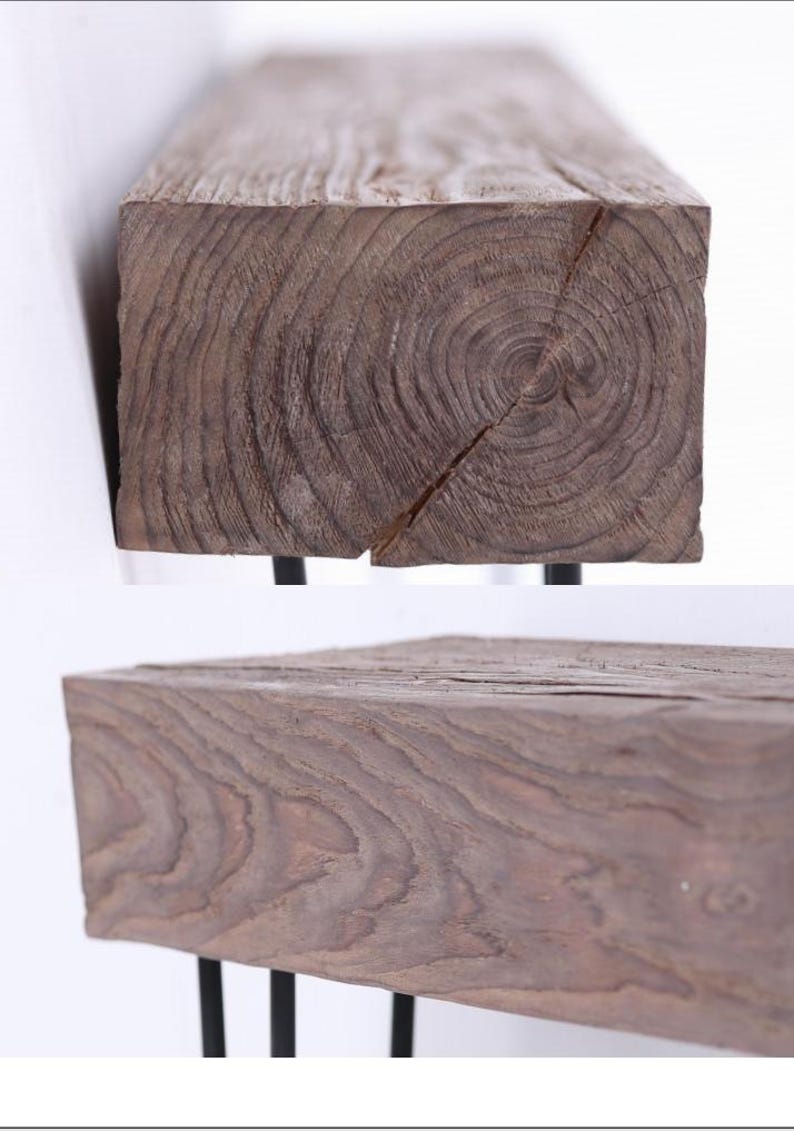 May include: A rustic wooden bench with a dark brown finish. The bench features a thick, rectangular wooden top with visible wood grain and a crack. It is supported by black metal legs, creating a contrast in textures and colors.