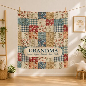 May include: A patchwork quilt featuring a variety of floral and blue gingham squares in red, blue, and cream tones. A central cream-colored oval label displays the text GRANDMA in large letters, followed by the names Emma, Logan, Hannah, Amy, Charles.