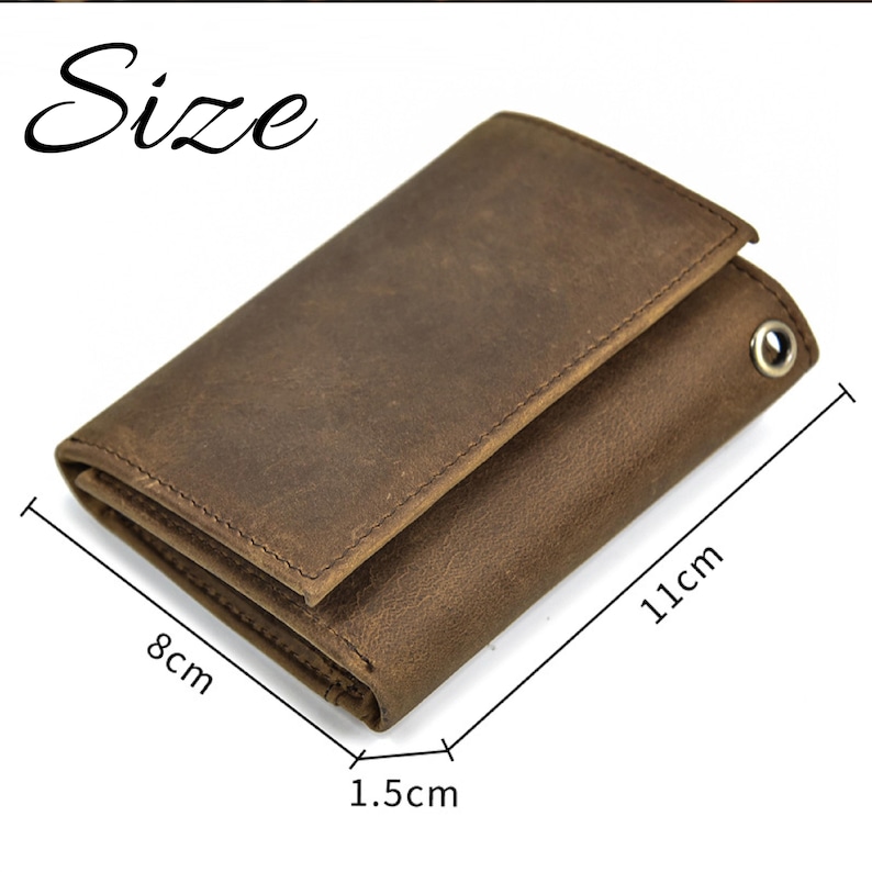 May include: A brown leather wallet with a worn, textured appearance. The wallet is 11 cm long, 8 cm wide, and 1.5 cm thick. It has a metal eyelet and a folded design. The word "Size" is written in a cursive font.