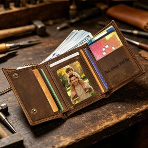 May include: Open brown leather wallet with multiple card slots, a photo, and cash. The wallet is embossed with the text "Dad, Always With Me". The wallet is open, revealing a photo of a man and a child.