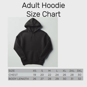 May include: Black adult hoodie with a size chart. The size chart shows chest measurements from 19 to 30 inches and body lengths from 26 to 32 inches. The hoodie has a hood and a front pocket.