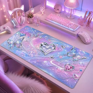 May include: A rectangular desk mat featuring a gradient of pastel pink, purple, and blue colors. The design includes two large butterflies with iridescent wings, a central metallic silver heart, a smaller pink heart, and scattered stars.