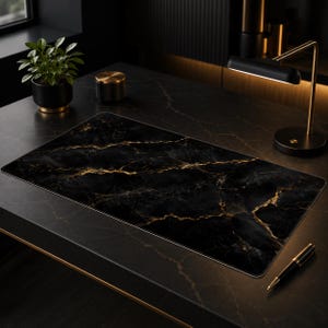May include: A rectangular desk mat featuring a black marble pattern with prominent gold veining. The mat has a smooth surface and rounded corners, designed to provide a flat workspace for a computer mouse and keyboard on a dark surface.