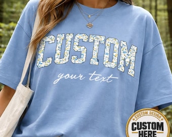 Personalized Cornflower Blue Floral Varsity Shirt, Custom Block Letter Flower Tee, Aesthetic Script Text Floral Top, Trendy Blue T-Shirt