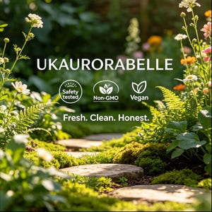 May include: A garden path with stepping stones, surrounded by lush greenery and colorful flowers. The image includes the text "UKAUROABELLE", along with icons indicating safety testing, non-GMO, and vegan attributes. The tagline reads "Fresh. Clean. Honest."