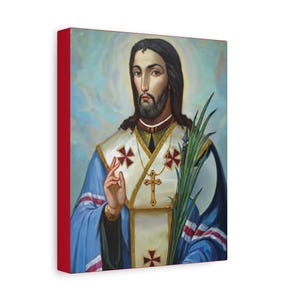 May include: A canvas print featuring a religious figure with long dark hair and a beard, wearing a blue robe with white and gold accents. The figure holds a green plant and a gold cross. The canvas has a red border.