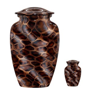 May include: A large and a small cremation urn, both featuring a glossy brown and black giraffe-like pattern with a smooth, rounded lid. The urns have a bulbous, tapered shape with a polished finish that reflects light across the textured surface.